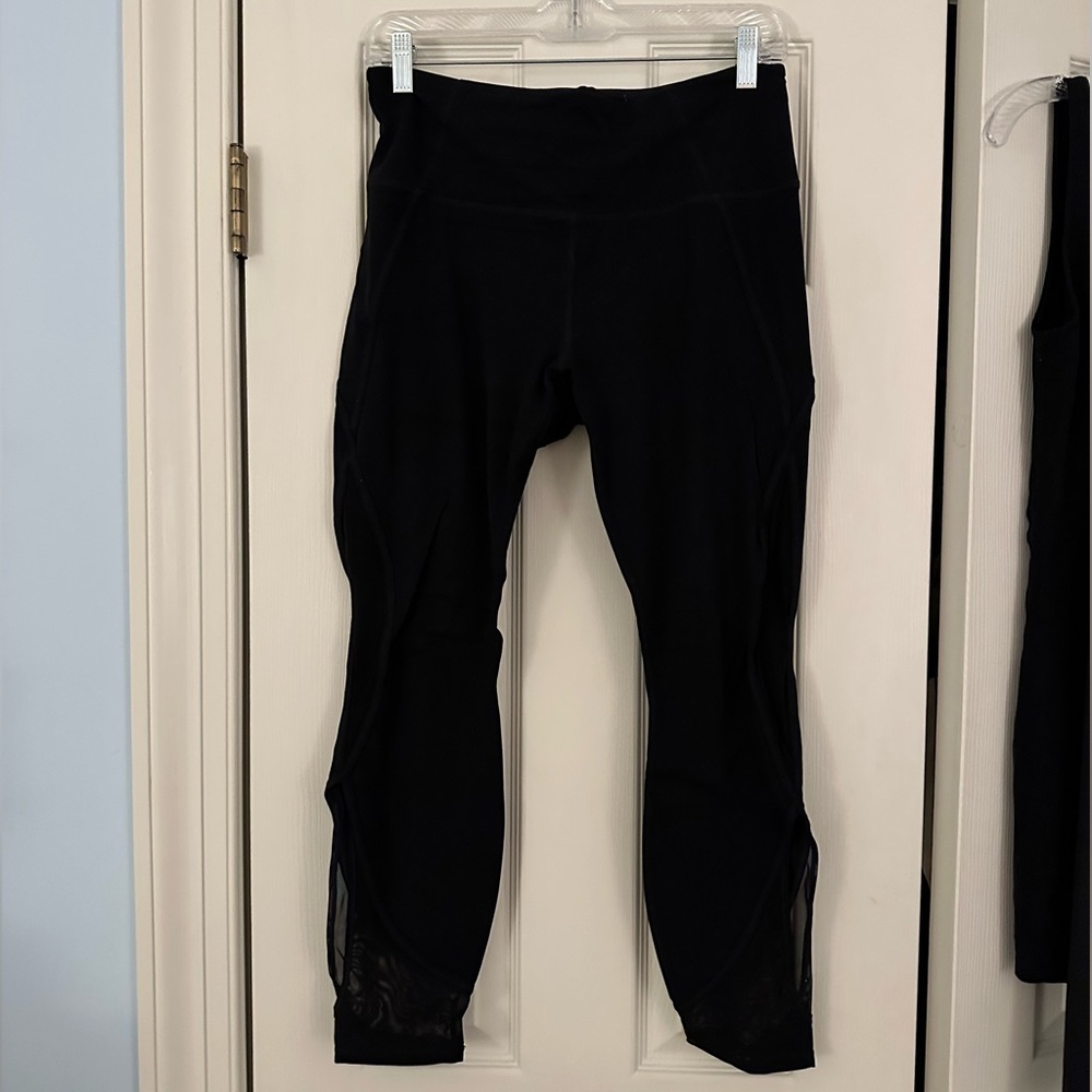 Athleta 7/8 length black leggings - mesh detailing on the side of the leg